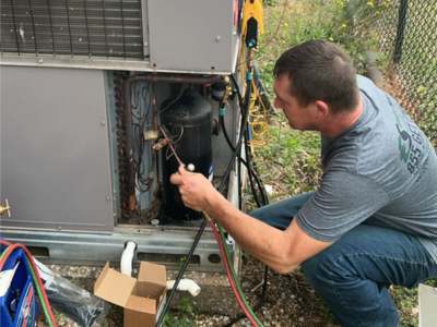 Engle Services HVAC Technician Repairing AC unit in Alabaster, Alabama