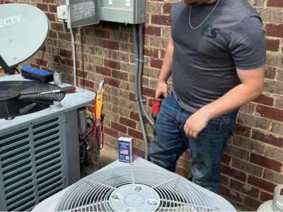 Engle Services HVAC Technician installing an AC unit in Birmingham, Alabama