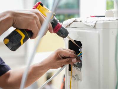 Technician inspecting an outdoor HVAC unit.