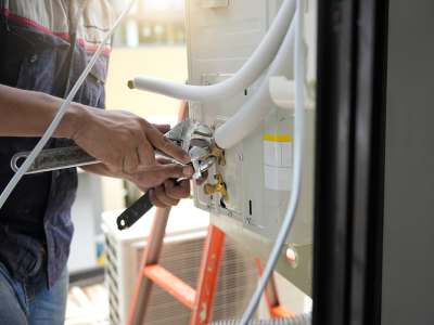HVAC Tech Performing Seasonal HVAC Maintenance