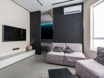Modern living room with comfortable furniture and HVAC system.