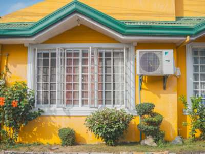 Outdoor AC condenser unit installed next to a residential home.