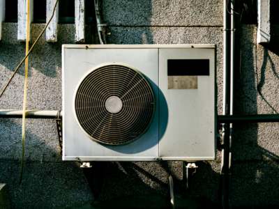 Wall-mounted air conditioner condenser unit.
